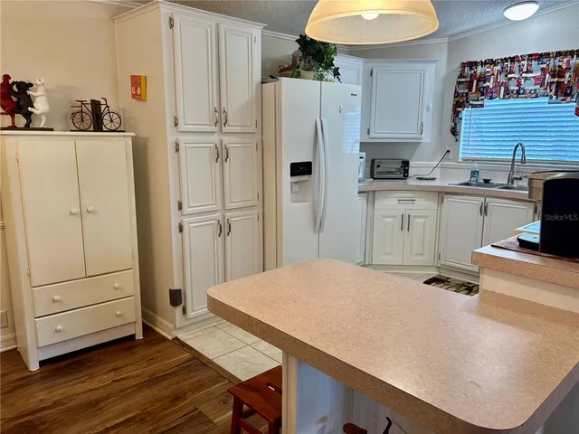a kitchen with a refrigerator and countertop