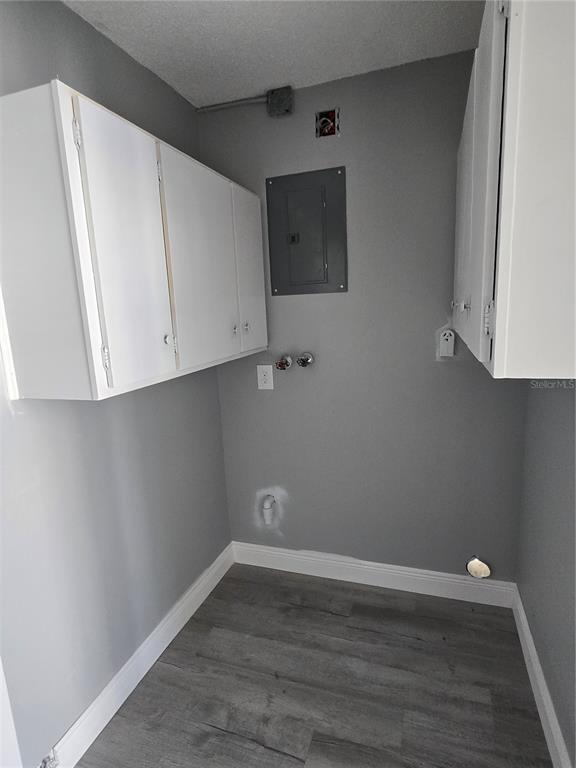 4836 Onyx Lane, Unit B New Port Richey, FL 34652 - Photo 13 of 13 a view of an empty room with wooden floor and cabinets