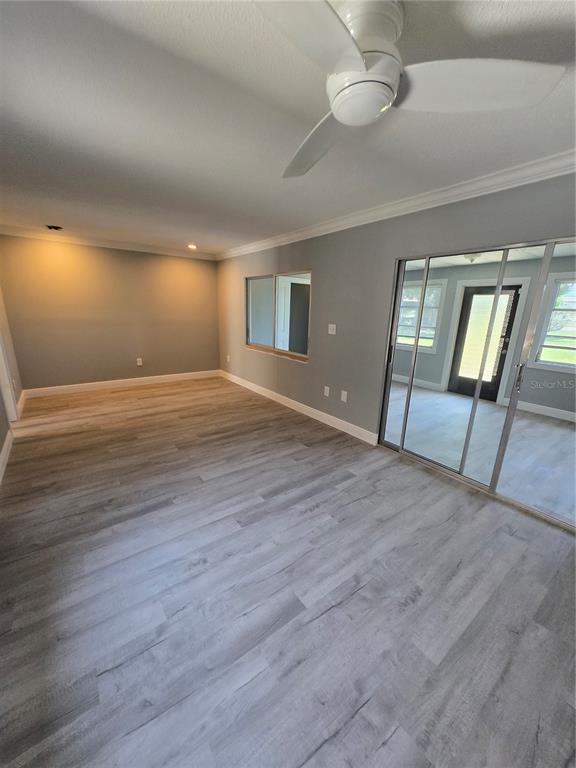 4836 Onyx Lane, Unit B New Port Richey, FL 34652 - Photo 2 of 13 a view of an empty room with wooden floor and a window