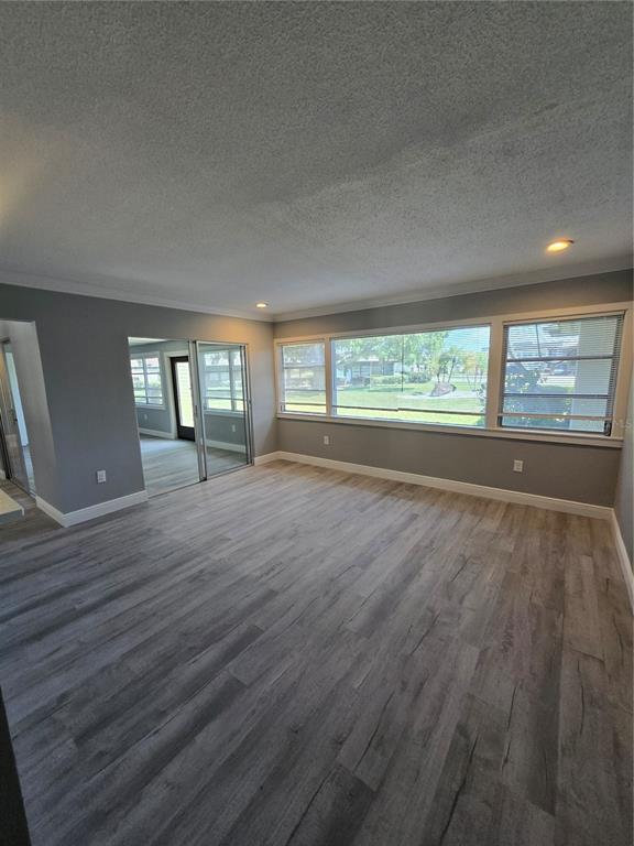 4836 Onyx Lane, Unit B New Port Richey, FL 34652 - Photo 3 of 13 a view of empty room with window and wooden floor
