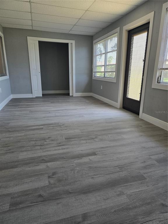 4836 Onyx Lane, Unit B New Port Richey, FL 34652 - Photo 4 of 13 an empty room with wooden floor and windows