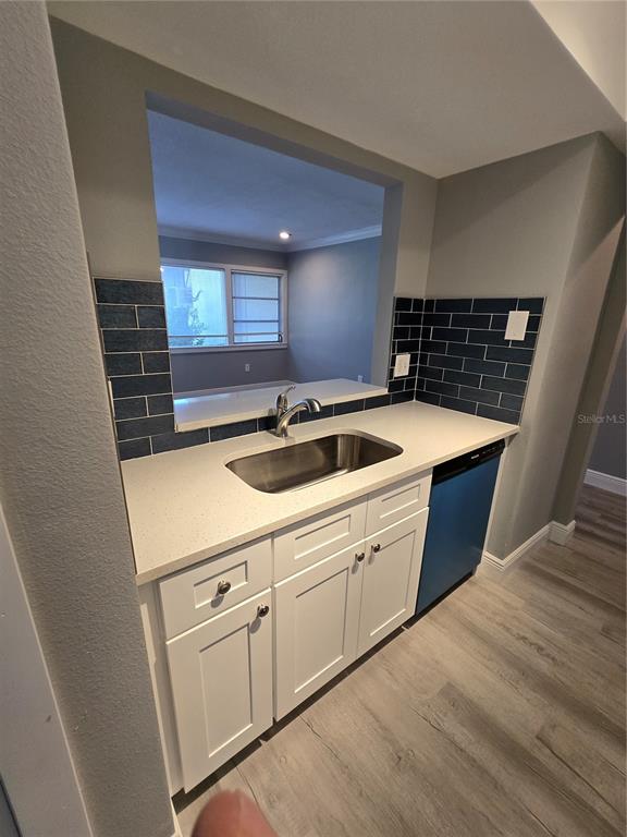 4836 Onyx Lane, Unit B New Port Richey, FL 34652 - Photo 7 of 13 a kitchen that has a sink and a stove in it