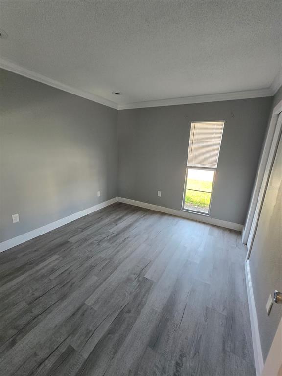 4836 Onyx Lane, Unit B New Port Richey, FL 34652 - Photo 10 of 13 an empty room with a window