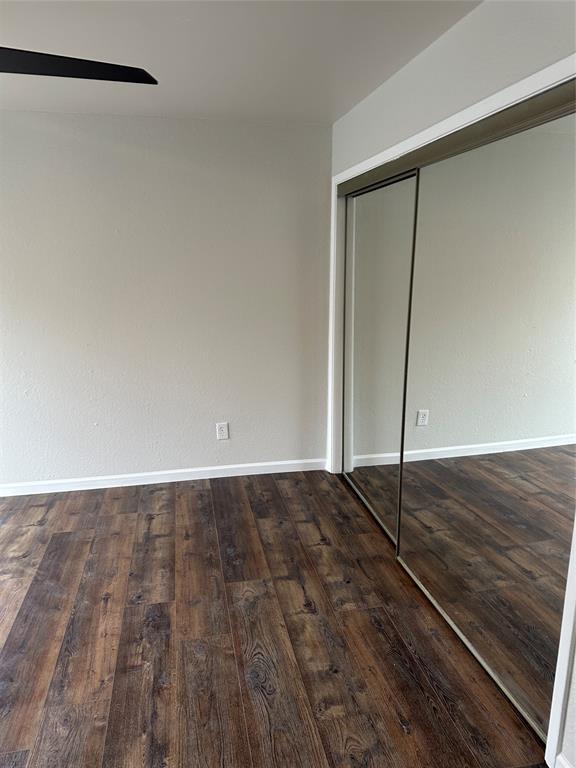 4520 Speedway, Unit A Austin, TX 78751 - Photo 7 of 9 Unfurnished bedroom with dark wood-style flooring, a closet, and ceiling fan