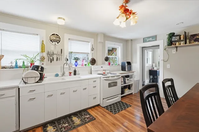 a kitchen with sink refrigerator and cabinets