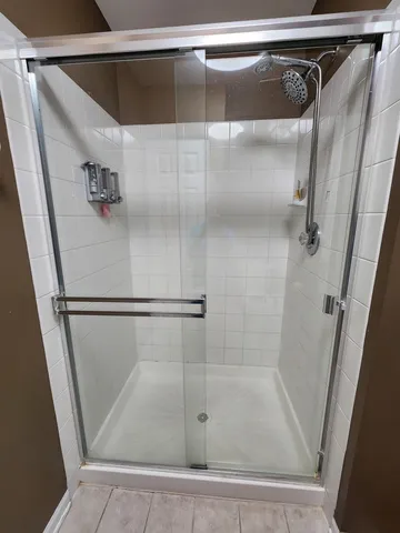 a bathroom with a glass shower door