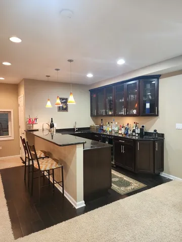 a view of a room with lots of furniture and a wooden floor