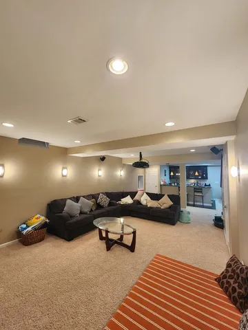 a bedroom with a bed a couch and a flat screen tv