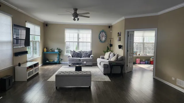a living room with furniture window and wooden floor