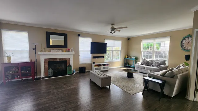 a living room with fireplace furniture and a wooden floor