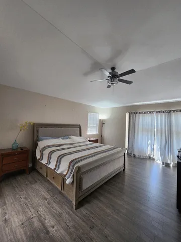 a bedroom with a bed and a ceiling fan