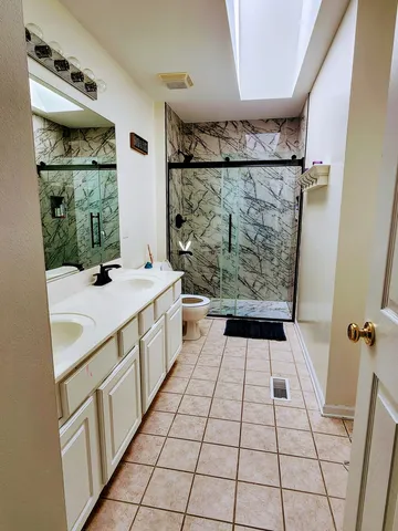 a bathroom with a sink a mirror and shower
