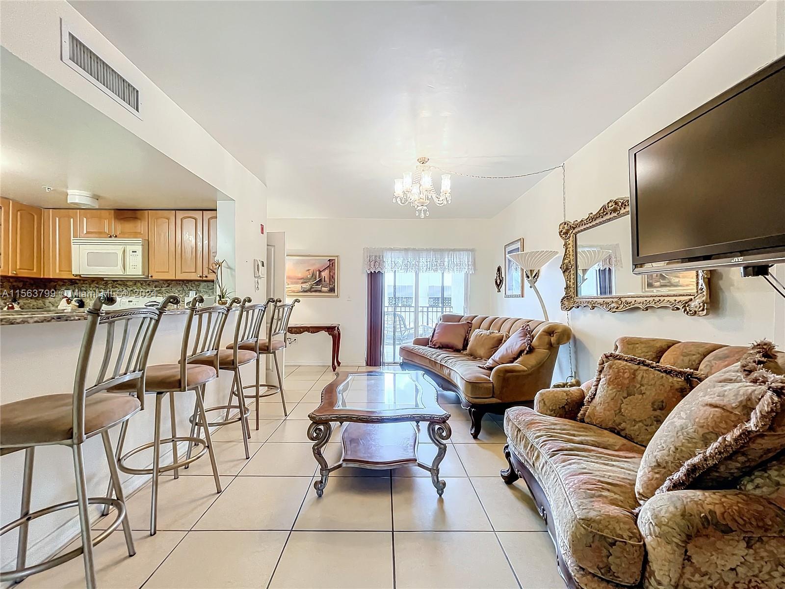 120 South Douglas Road, Unit 302 Miami, FL 33134 - Photo 6 of 28 a living room with furniture and a flat screen tv