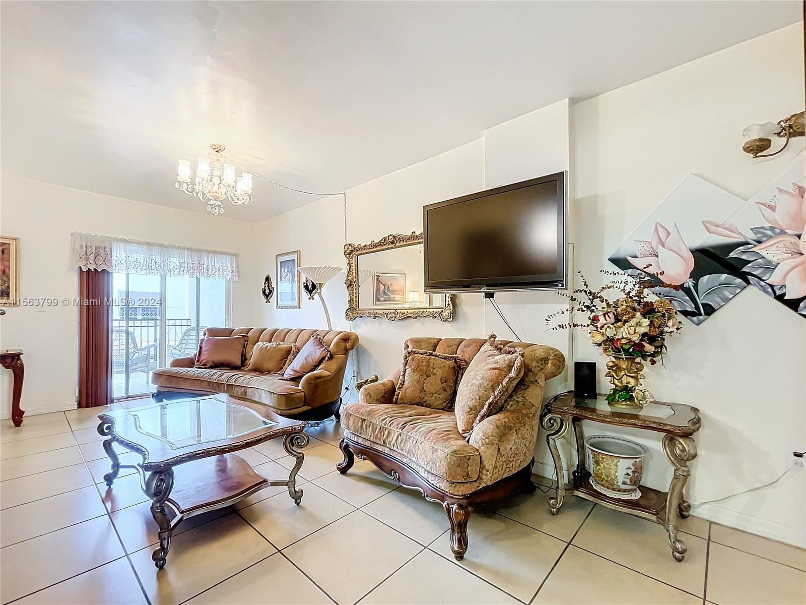 120 South Douglas Road, Unit 302 Miami, FL 33134 - Photo 7 of 28 a living room with furniture and a flat screen tv