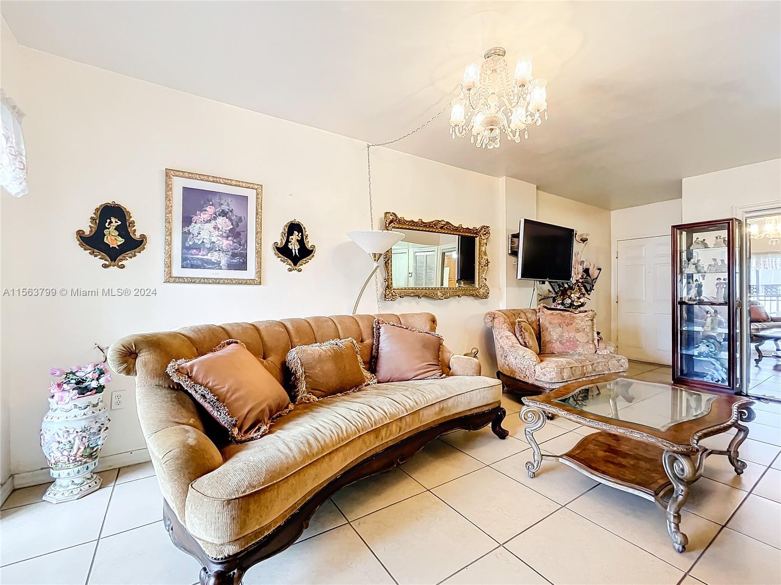 120 South Douglas Road, Unit 302 Miami, FL 33134 - Photo 8 of 28 a living room with furniture a flat screen tv and kitchen view