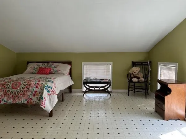 a room with gym equipment and glass door shower