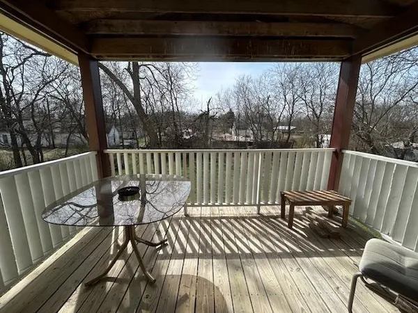 a view of a deck with chairs and wooden floor