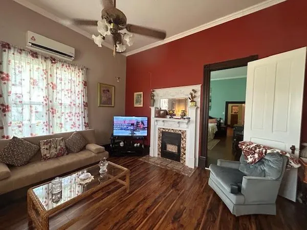 a living room with furniture fireplace and a large window
