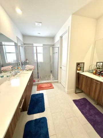 a spacious bathroom with a tub sink and mirror
