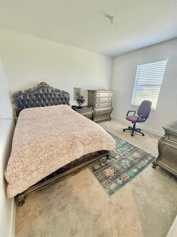 a bedroom with a bed and dresser