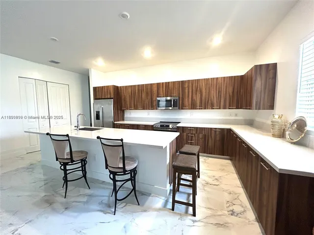 a kitchen with kitchen island granite countertop wooden cabinets and counter space