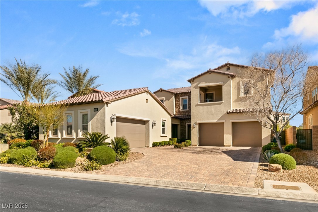 4039 Villa Rafael Drive Las Vegas, NV 89141 - Photo 11 of 45 Mediterranean / spanish-style house with stucco siding, decorative driveway, and a tiled roof