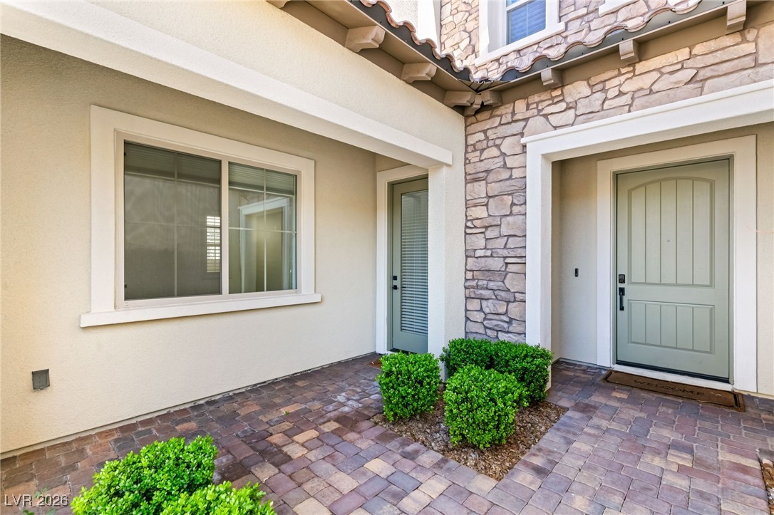 4039 Villa Rafael Drive Las Vegas, NV 89141 - Photo 12 of 45 Property entrance with stone siding and stucco siding