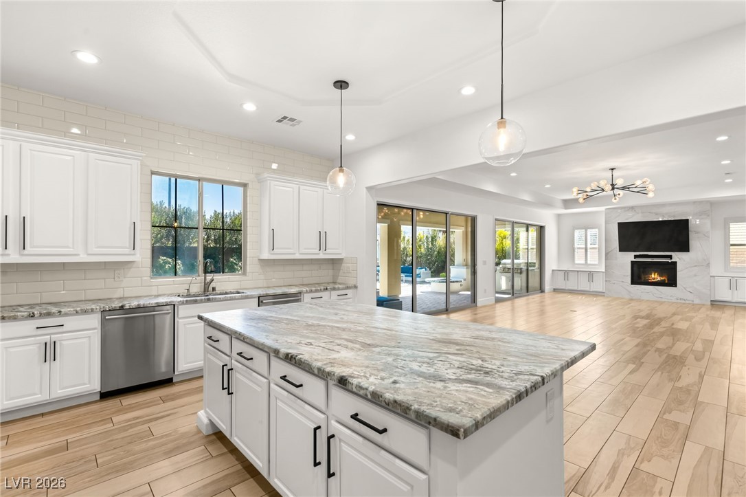 4039 Villa Rafael Drive Las Vegas, NV 89141 - Photo 2 of 45 Kitchen featuring wood tiled floors, recessed lighting, white cabinetry, and stainless steel dishwasher