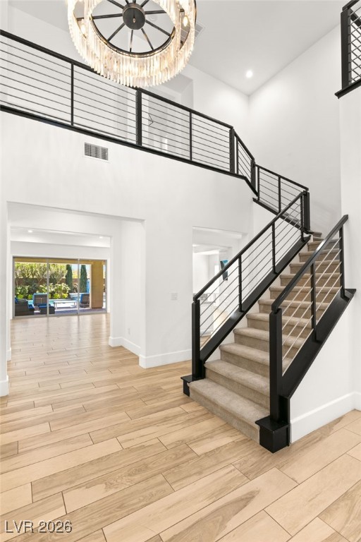 4039 Villa Rafael Drive Las Vegas, NV 89141 - Photo 23 of 45 Staircase featuring wood finished floors, a high ceiling, and recessed lighting