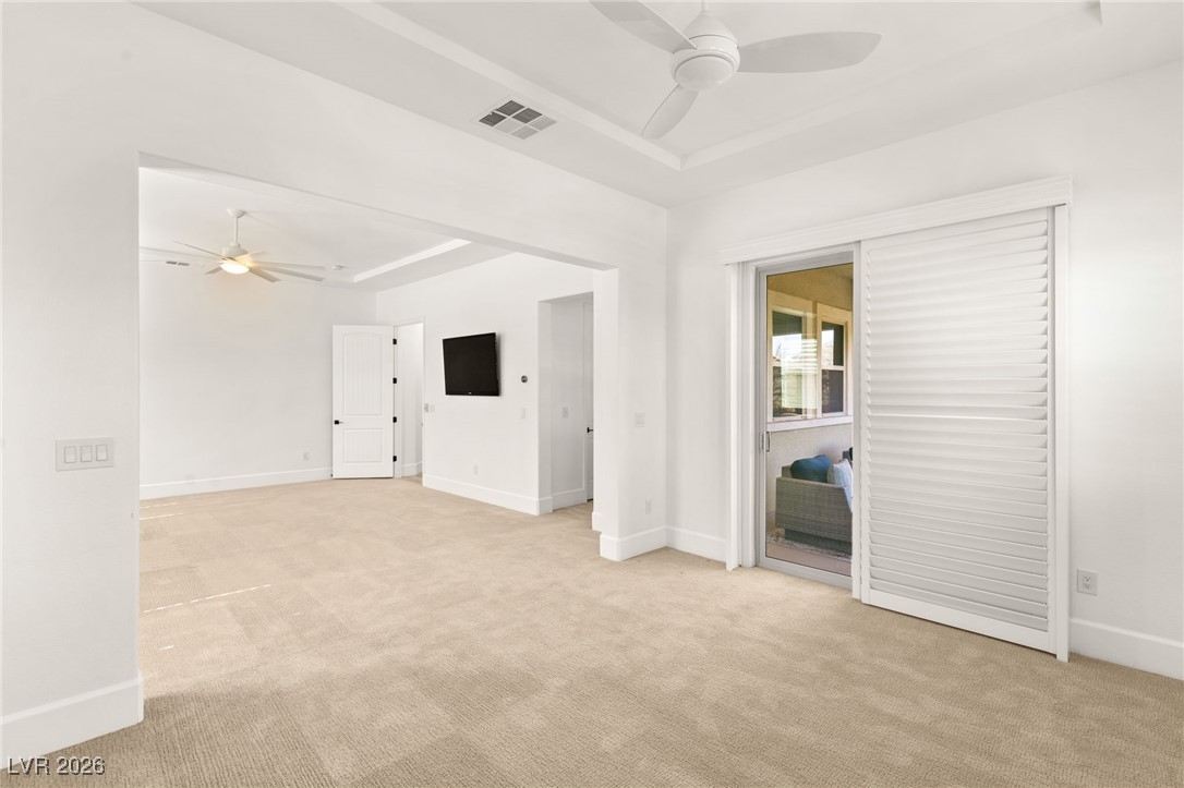 4039 Villa Rafael Drive Las Vegas, NV 89141 - Photo 25 of 45 Spare room with ceiling fan, light colored carpet, and a raised ceiling