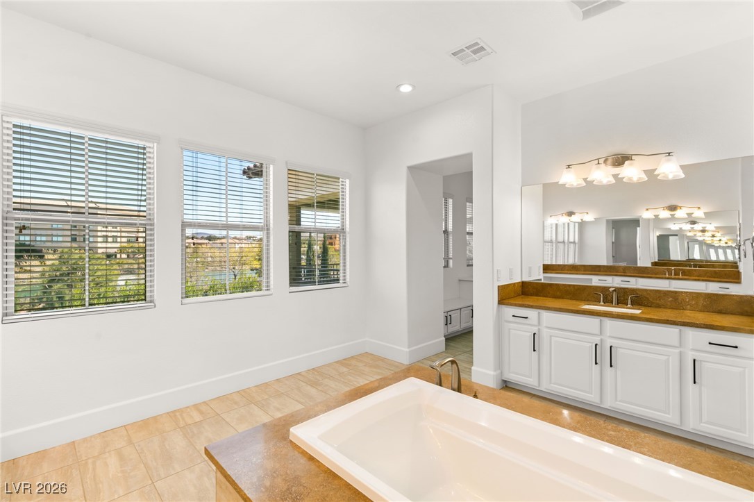 4039 Villa Rafael Drive Las Vegas, NV 89141 - Photo 27 of 45 Bathroom featuring vanity, light tile patterned flooring, a garden tub, and recessed lighting