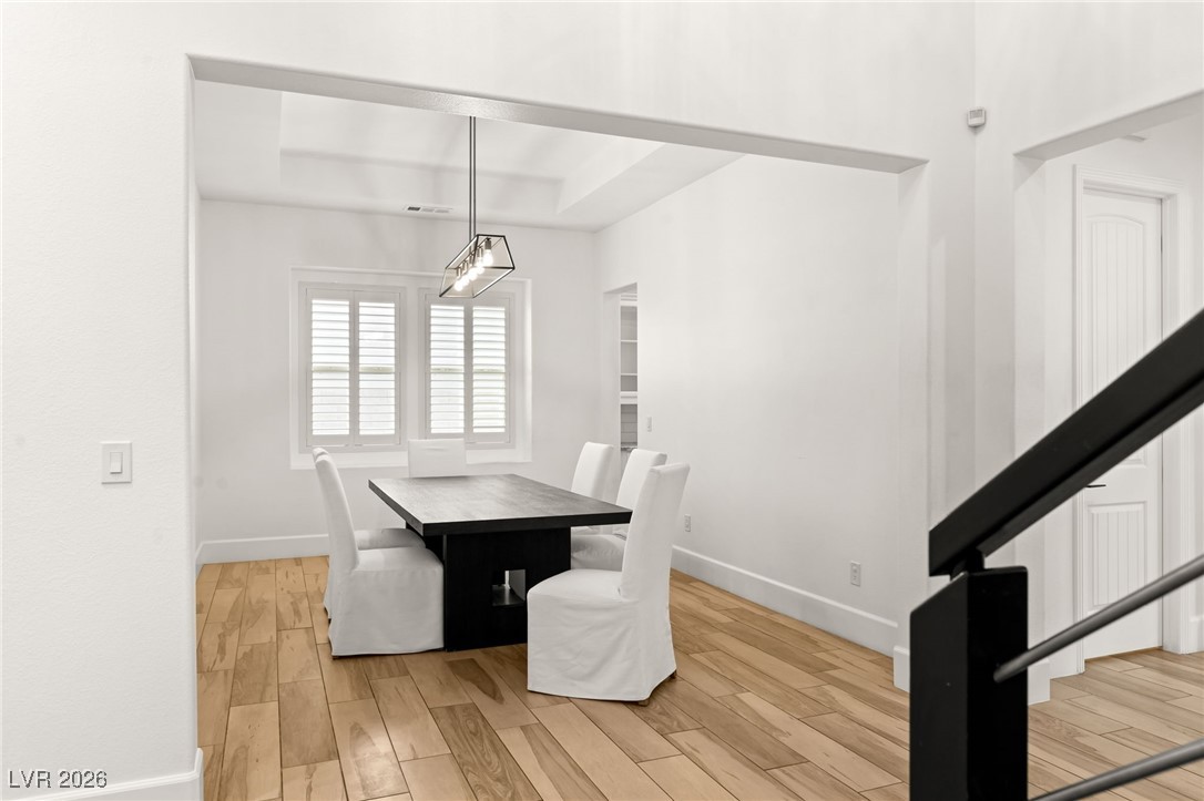 4039 Villa Rafael Drive Las Vegas, NV 89141 - Photo 4 of 45 Unfurnished dining area featuring light wood finished floors and stairs