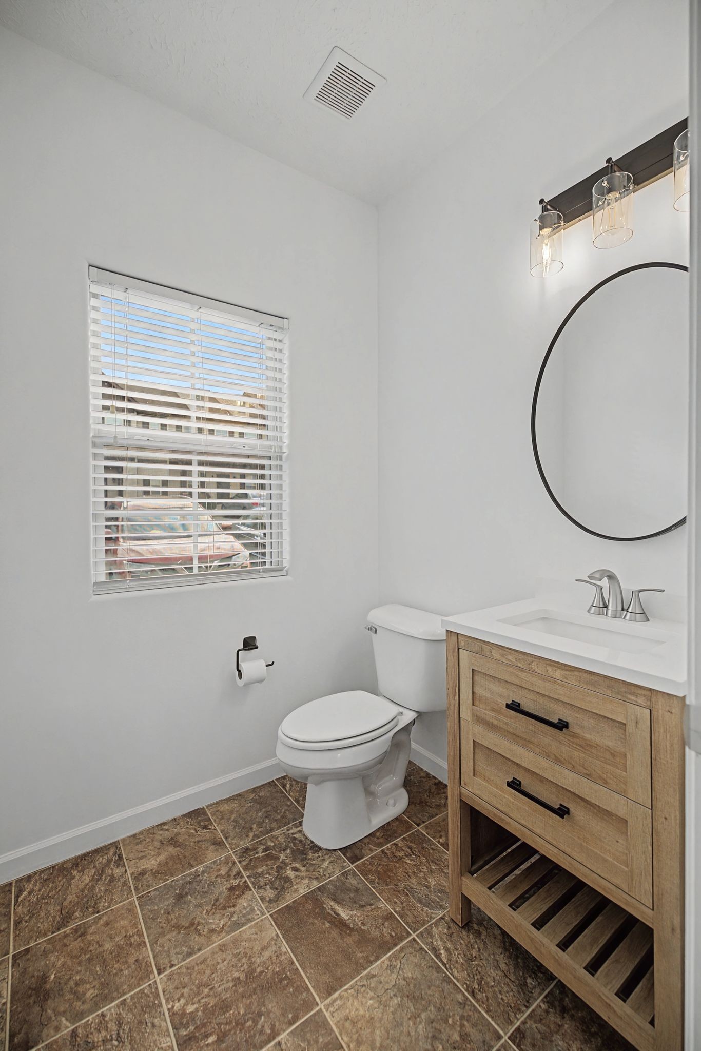 5304 Dan Post Way Murfreesboro, TN 37128 - Photo 14 of 32 a bathroom with a toilet a sink a mirror and a window