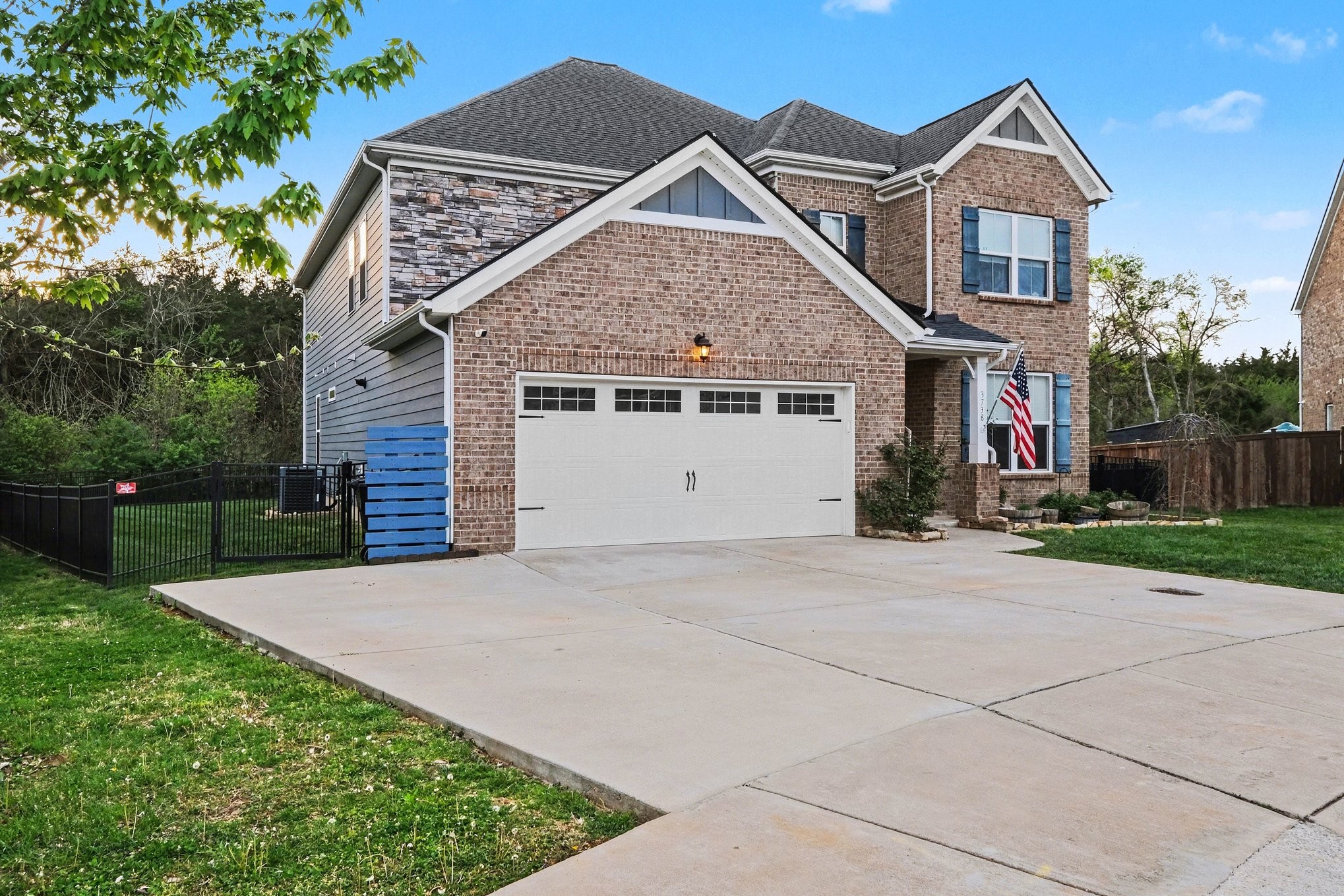3738 Magpie Lane Murfreesboro, TN 37128 - Photo 2 of 42 a front view of a house with a yard and garage
