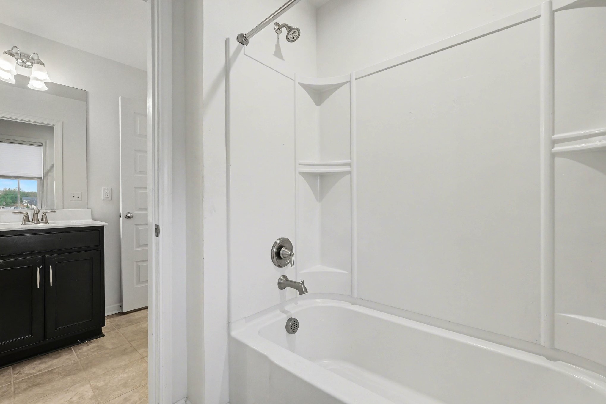 3738 Magpie Lane Murfreesboro, TN 37128 - Photo 30 of 42 a white bath tub sitting next to a bathroom sink