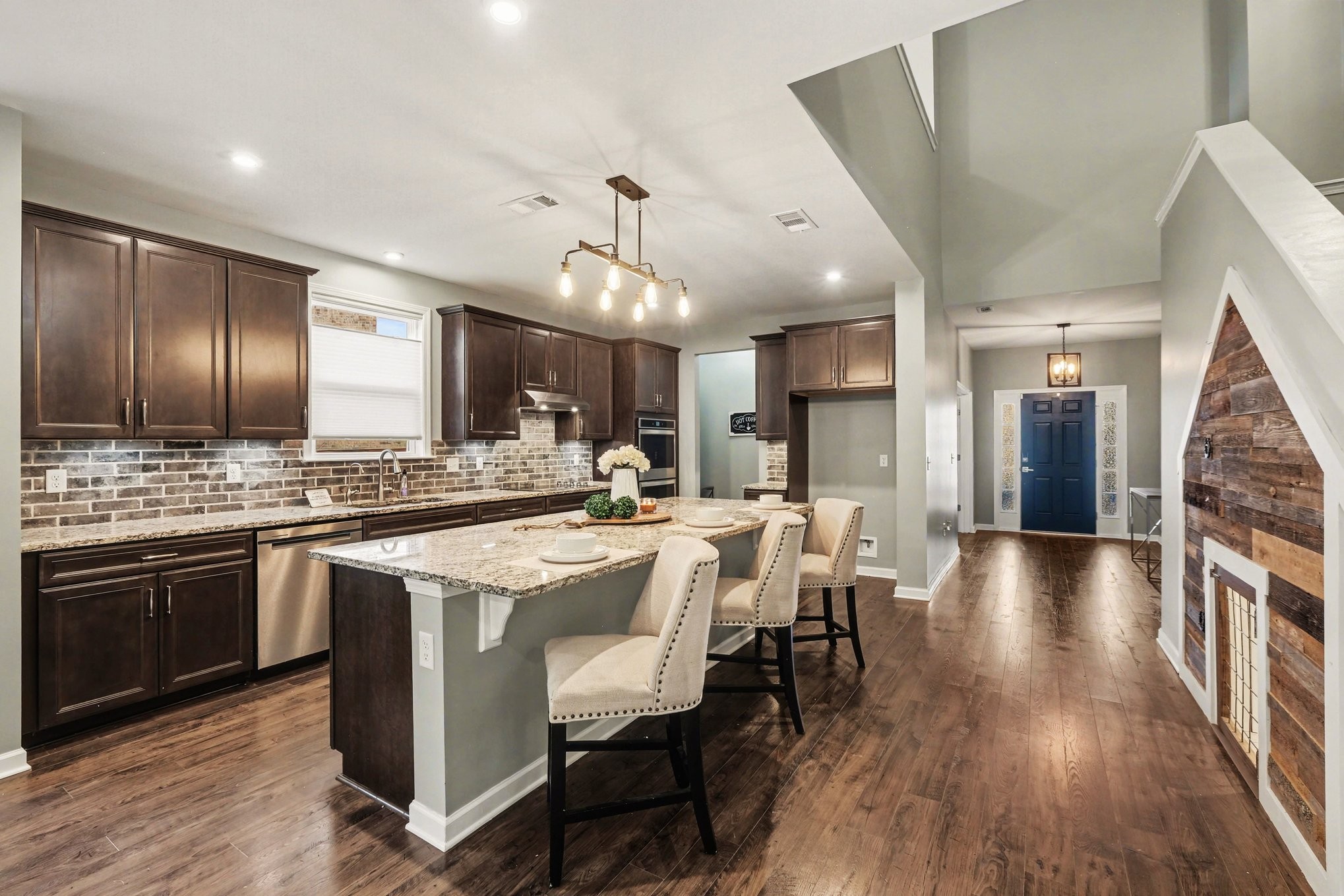 3738 Magpie Lane Murfreesboro, TN 37128 - Photo 10 of 42 a large kitchen with cabinets chairs and wooden floor