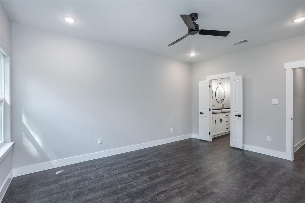 326 West Day Street Denison, TX 75020 - Photo 20 of 27 an empty room with wooden floor and windows