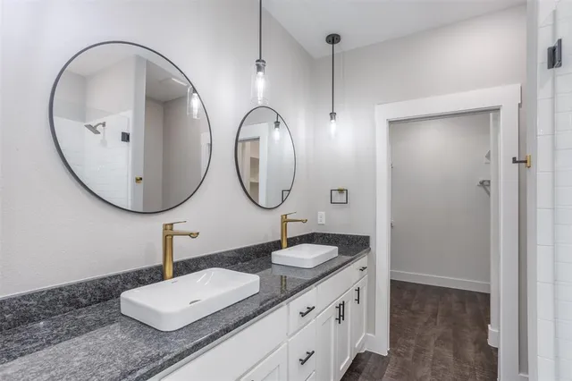 a bathroom with a double vanity sink and a mirror
