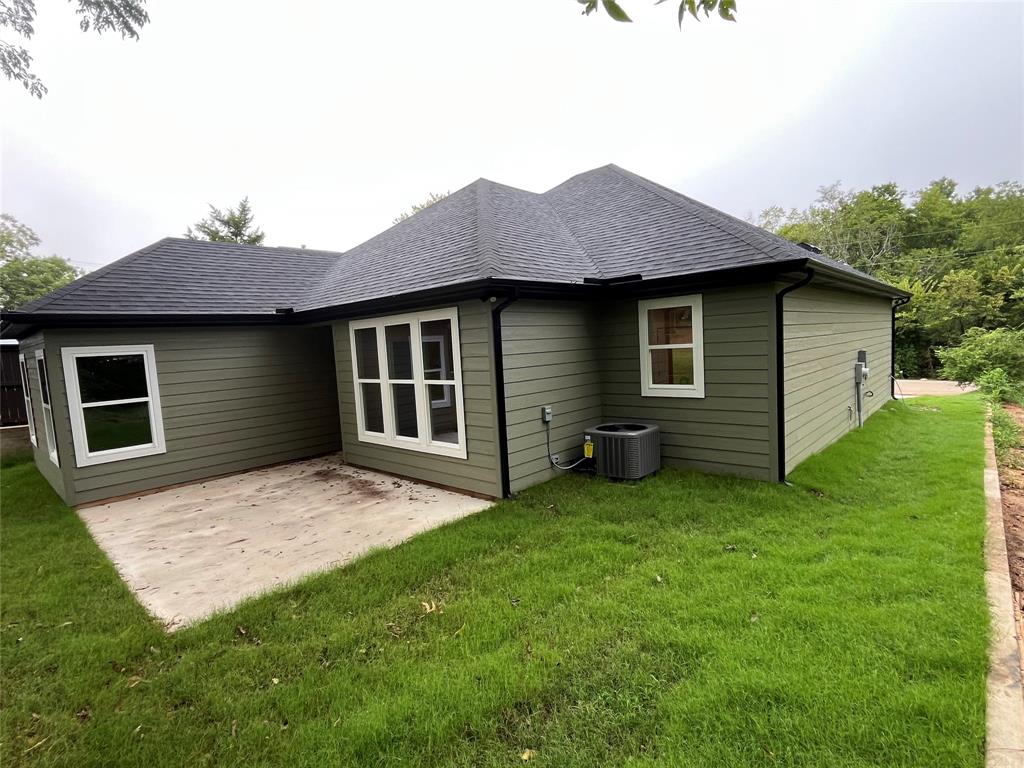 326 West Day Street Denison, TX 75020 - Photo 6 of 27 a view of a house with a yard