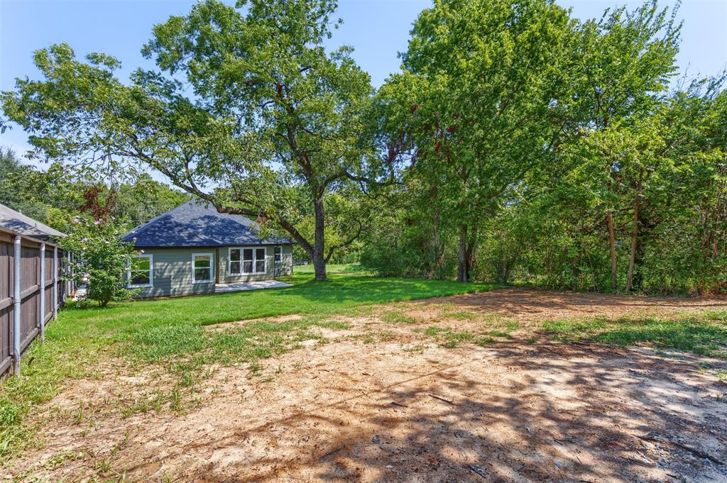 326 West Day Street Denison, TX 75020 - Photo 10 of 27 a view of a big yard next to a house