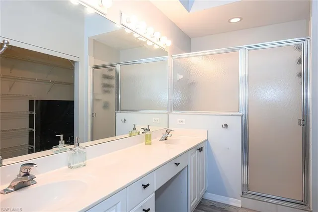 a bathroom with a double vanity sink mirror and double