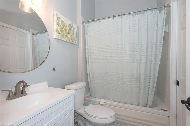 a bathroom with a toilet a sink and a mirror