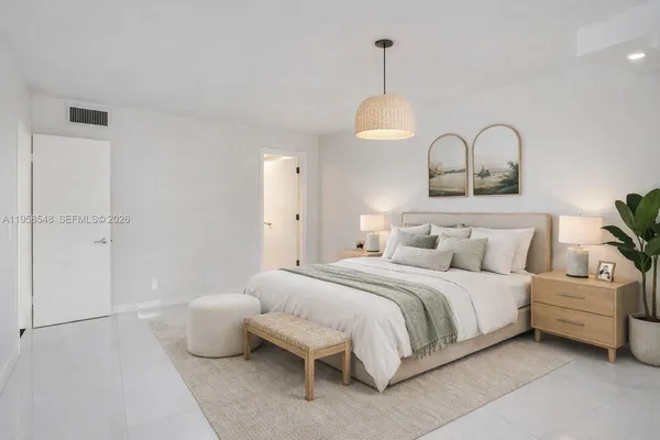 a bedroom with a bed and a chandelier
