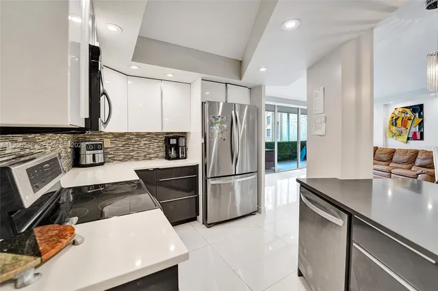 a kitchen with a refrigerator sink and stove