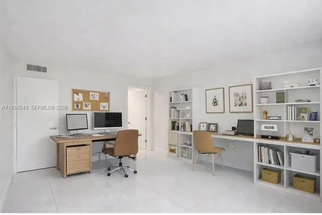 a work room with furniture and a bookshelf