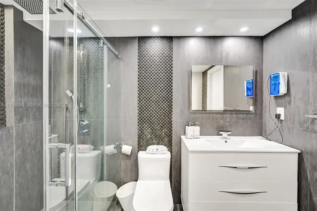 a bathroom with a toilet sink and shower