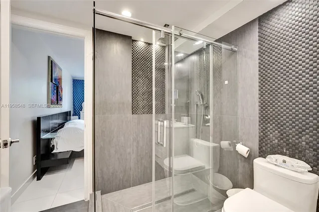 a bathroom with a toilet and a shower