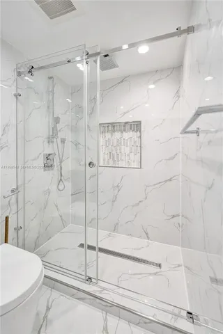 a bathroom with a shower and a toilet