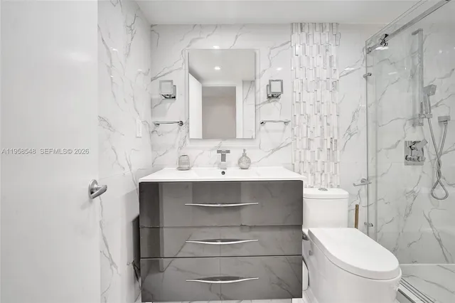 a bathroom with a sink toilet and shower