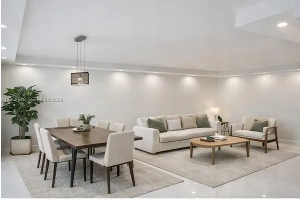 a living room with furniture and a potted plant
